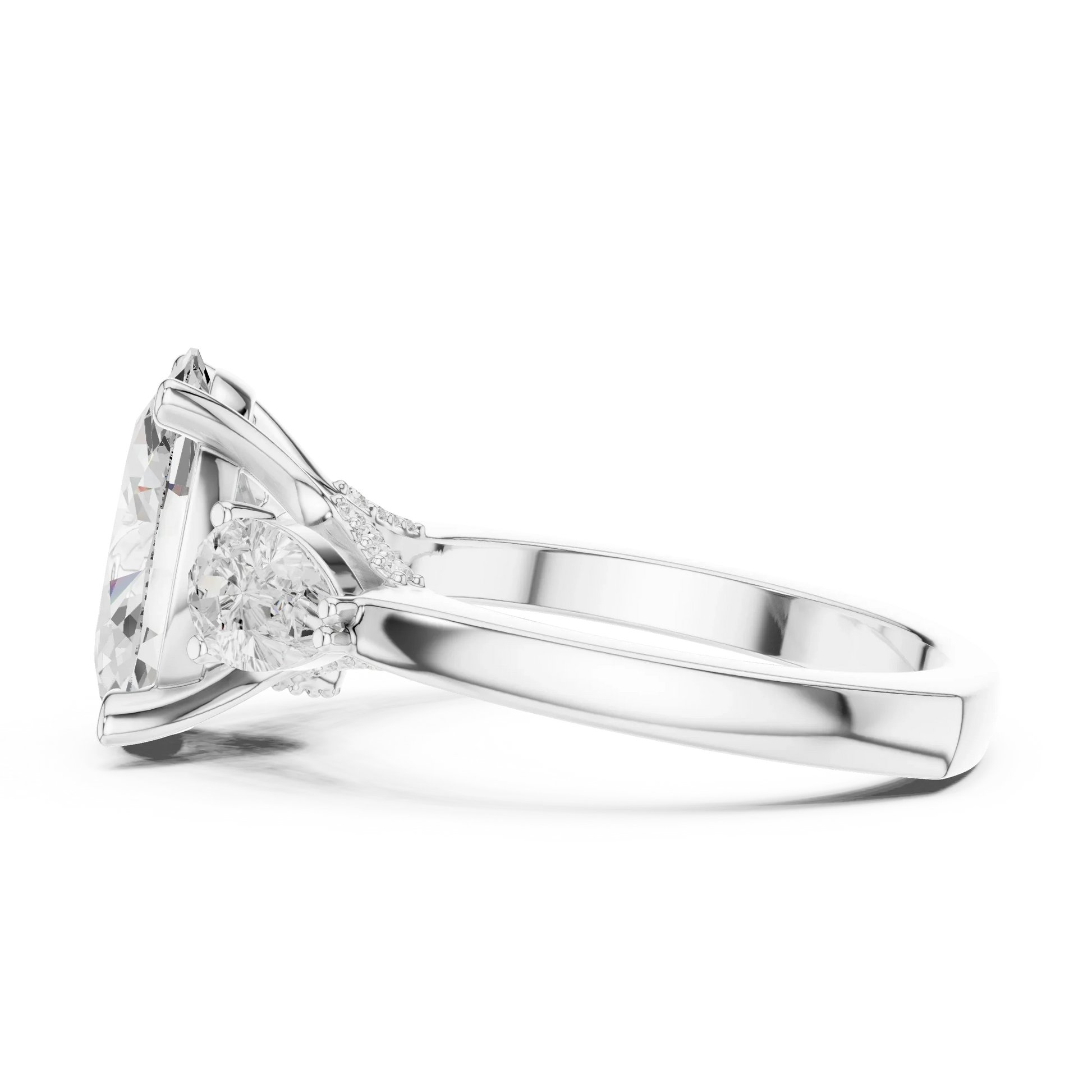 Side view of white gold oval three stone ring highlighting pear side stones and diamond setting