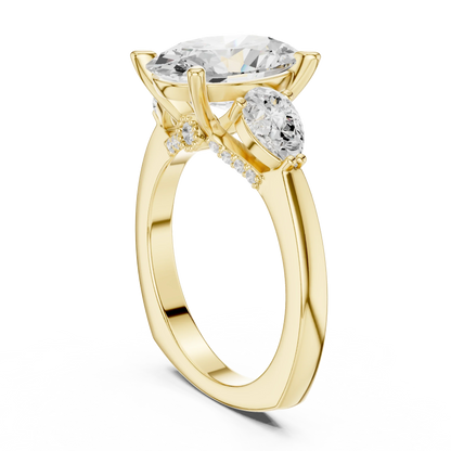 Back view of yellow gold oval three stone ring featuring pear side stones and smooth band