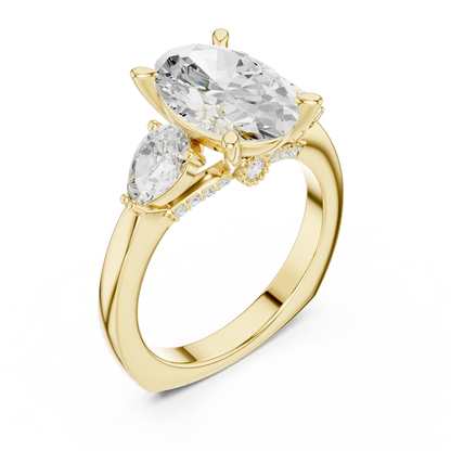 Front view of yellow gold oval three stone ring with pear side stones and lab-grown diamonds