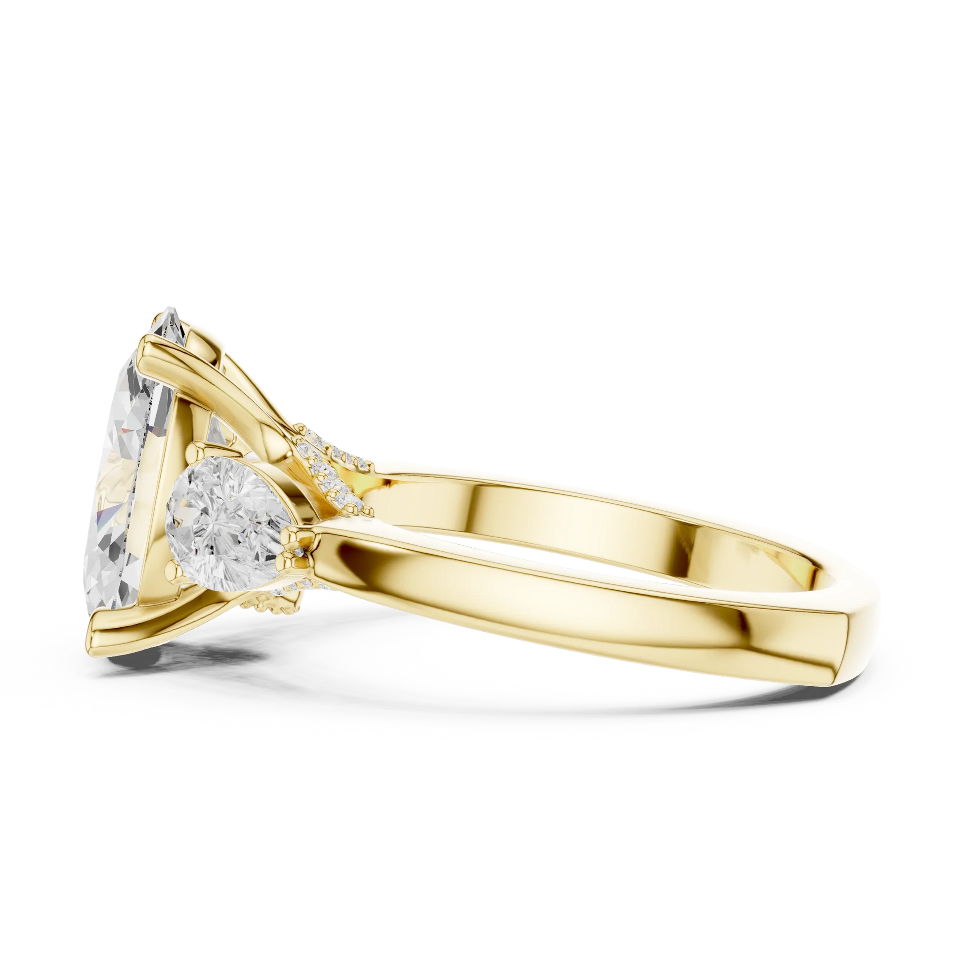 Side profile of yellow gold oval three stone ring highlighting pear side stones and structure
