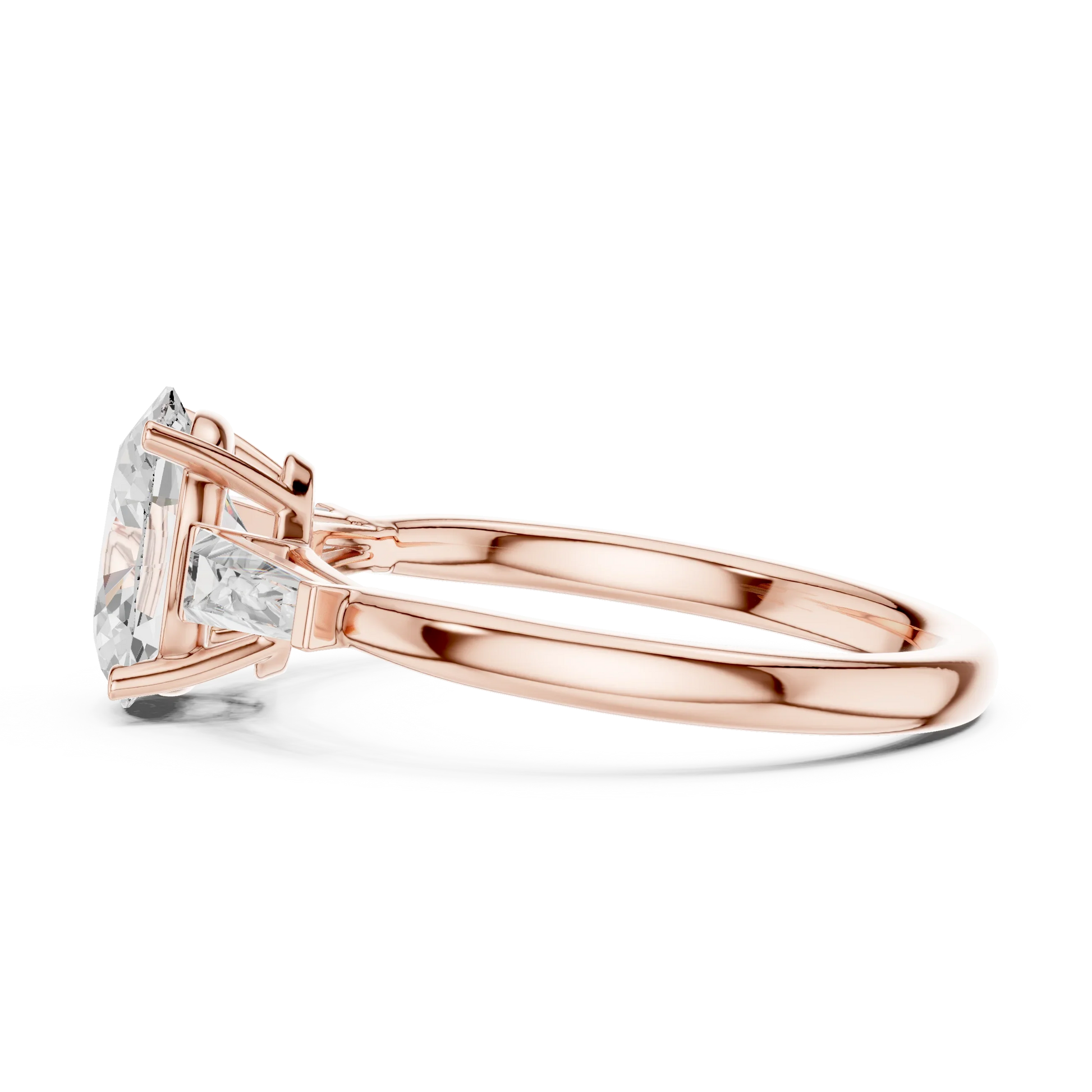 Side view of rose gold oval three stone ring highlighting tapered baguette side stones and diamond setting