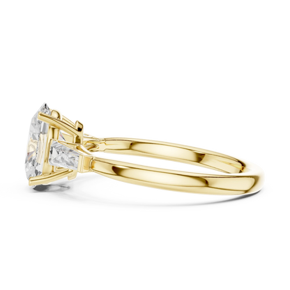Side profile of yellow gold oval three stone ring highlighting tapered baguette side stones and structure