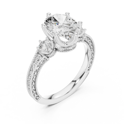 Front view of white gold oval three stone vintage ring with round brilliant side stones and filigree milgrain detailing