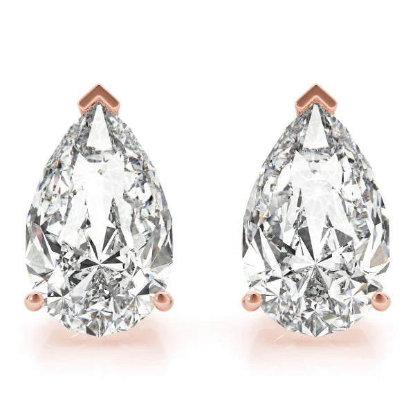 Pair of pear-shaped diamond earrings with rose gold prongs on a white background