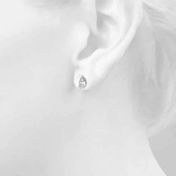 Silver earring on a girl's ear in the background