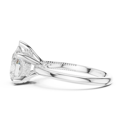 Side view of white gold pear cut solitaire ring highlighting hidden halo and domed band design