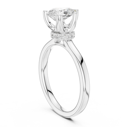 Back side view of white gold pear cut solitaire ring showing hidden halo and domed band details
