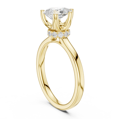 Back side view of yellow gold pear cut solitaire ring showing hidden halo and domed band details