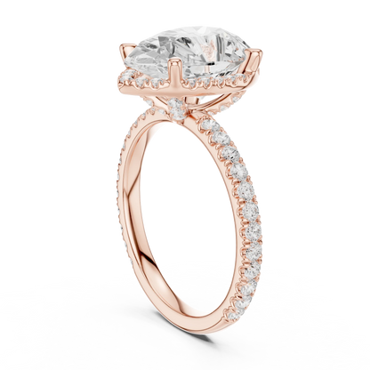 Back side view of rose gold pear cut solitaire ring showing hidden halo and thin pav茅 band structure
