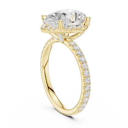 Back side view of yellow gold pear cut solitaire ring showing hidden halo and thin pav茅 band details