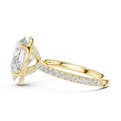 Side view of yellow gold pear cut solitaire ring highlighting hidden halo and thin pav茅 band design