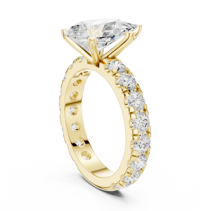 Back side view of yellow gold pear cut solitaire ring showing pave band and mounting details