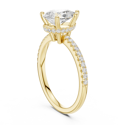 Back side view of yellow gold pear cut solitaire ring showing thin pave band and mounting details