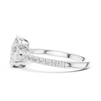 Side view of white gold pear three stone diamond ring with half moon side stones and pave band, highlighting setting profile.