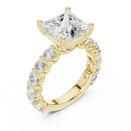 Front view of yellow gold princess cut solitaire ring with shared prong large stone band and center gemstone