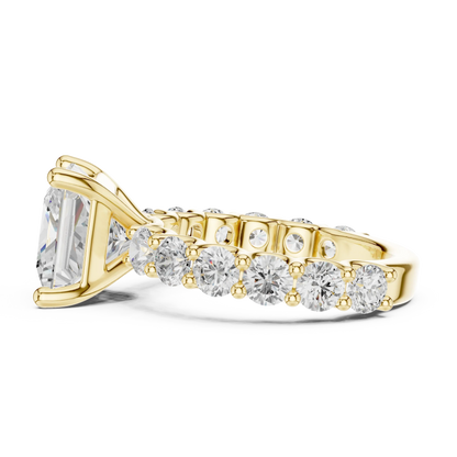 Side view of yellow gold princess cut solitaire ring with shared prong large stone band and prong setting