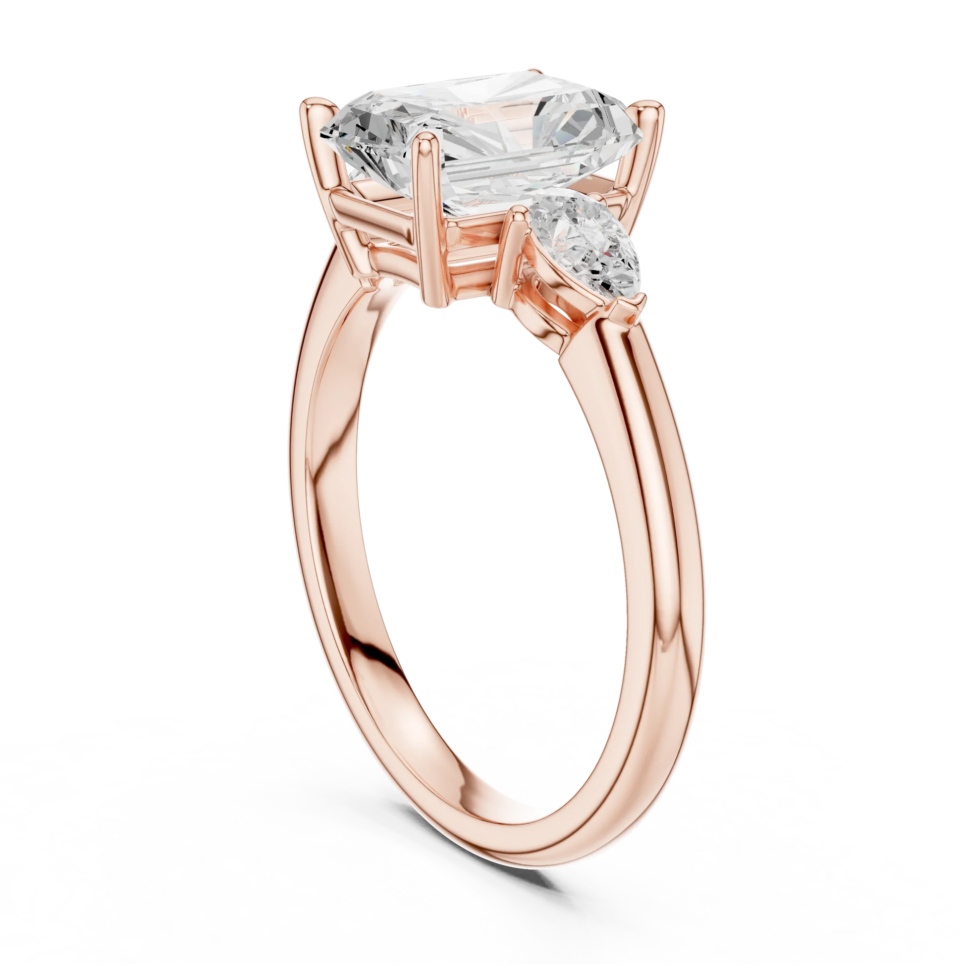 Back side view of rose gold radiant three-stone ring with pear side stones and lab-grown diamond 鈥?Australia