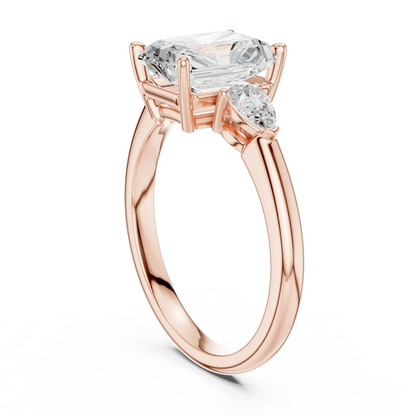 Back side view of rose gold radiant three-stone ring with pear side stones and lab-grown diamond 鈥?Australia