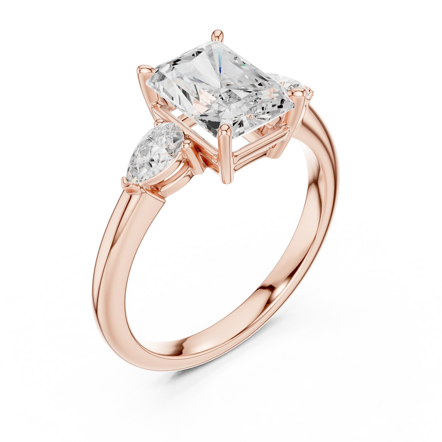 Front view of rose gold radiant three-stone ring with pear side stones and lab-grown diamond 鈥?Australia
