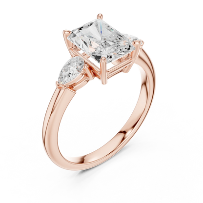 Front view of rose gold radiant three-stone ring with pear side stones and lab-grown diamond 鈥?Australia