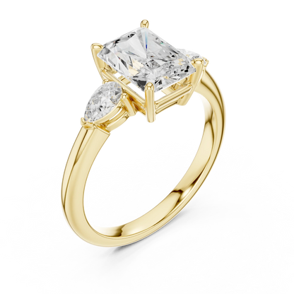 Front view of yellow gold radiant three-stone ring with pear side stones and lab-grown diamond 鈥?Australia