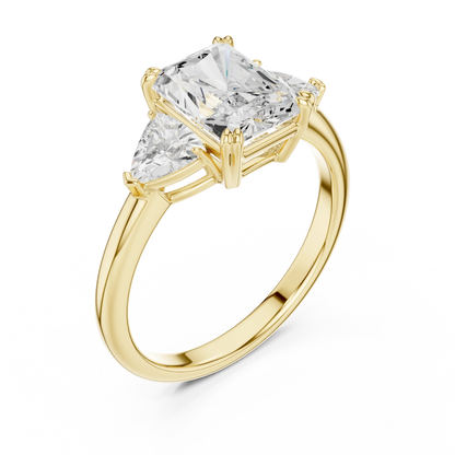 Front view of yellow gold radiant three-stone ring with trillion cut side stones and lab-grown diamond 鈥?Australia