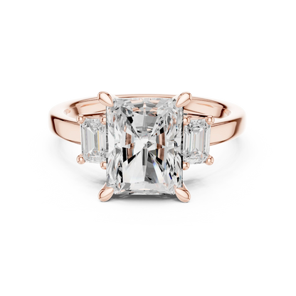 Radiant three stone ring with step cut trapezoid side stones and lab-grown diamonds in rose gold with modern romantic finish