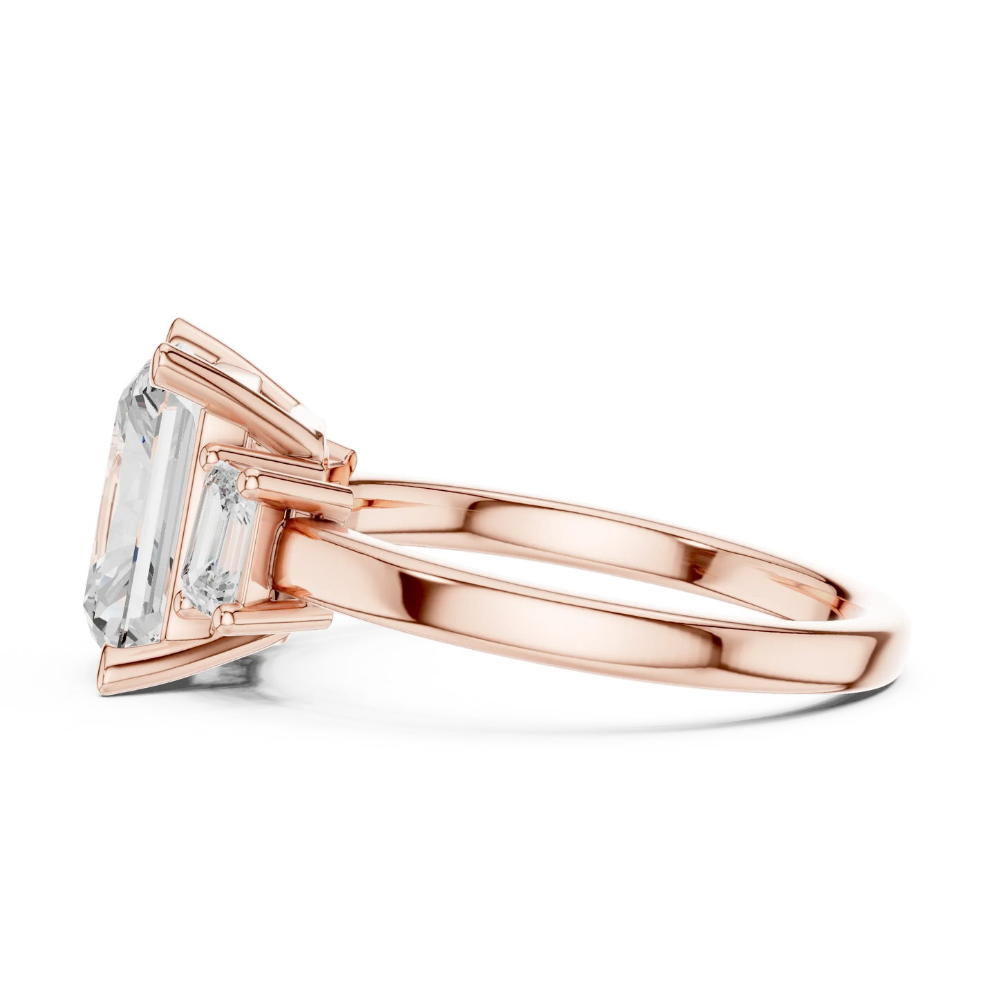 Side view of rose gold radiant three stone ring highlighting step cut trapezoid side stones and diamond setting