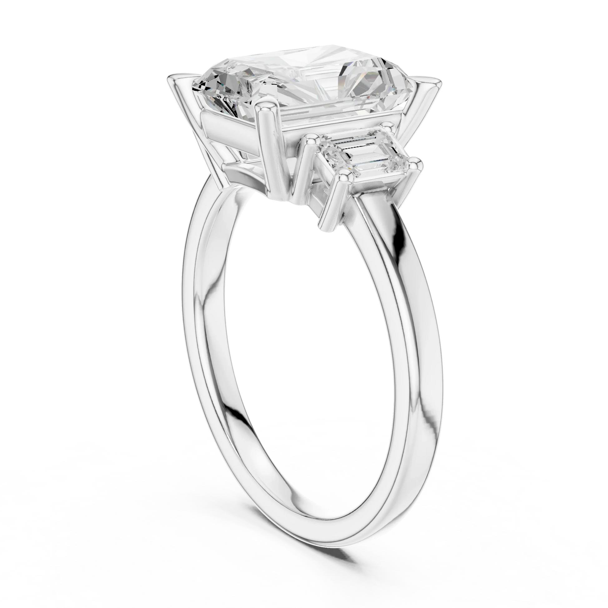 Back view of white gold radiant three stone ring featuring step cut trapezoid side stones and polished band