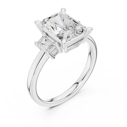 Front view of white gold radiant three stone ring with step cut trapezoid side stones and lab-grown diamonds