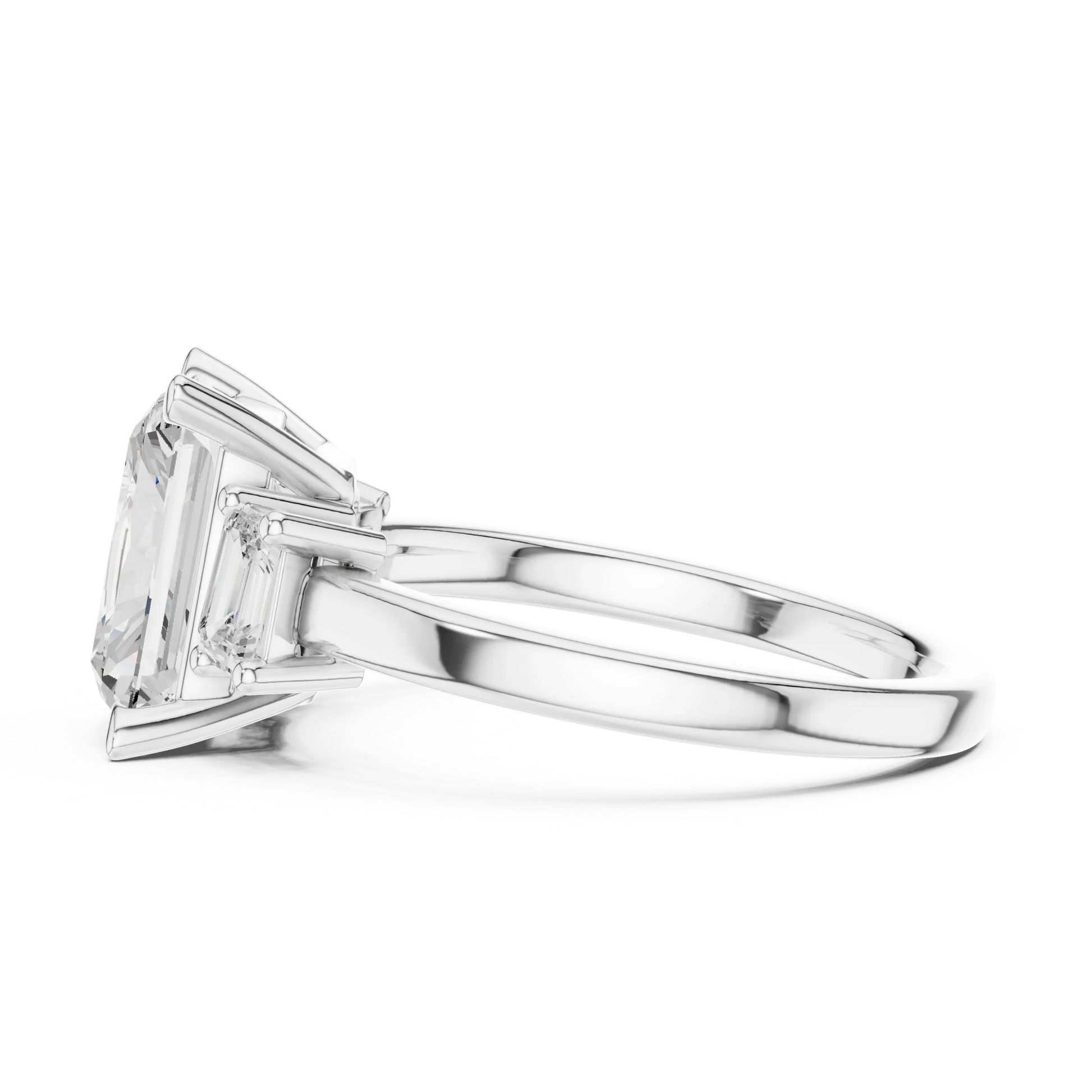 Side view of white gold radiant three stone ring highlighting step cut trapezoid side stones and diamond setting