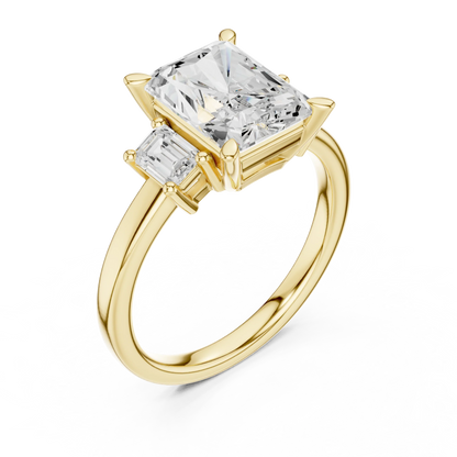 Front view of yellow gold radiant three stone ring with step cut trapezoid side stones and lab-grown diamonds