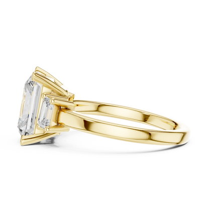 Side profile of yellow gold radiant three stone ring highlighting step cut trapezoid side stones and structure