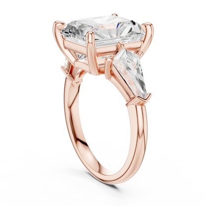 Back view of rose gold radiant three stone ring featuring trillion side stones and polished band