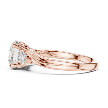 Side view of rose gold three stone ring highlighting twisted vine shank and round brilliant diamond setting