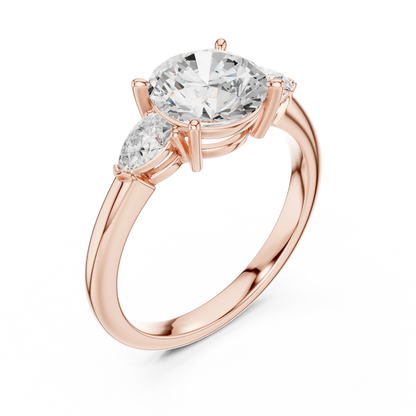 Front view of rose gold round three-stone ring with pear side stones and lab-grown diamond 鈥?Australia
