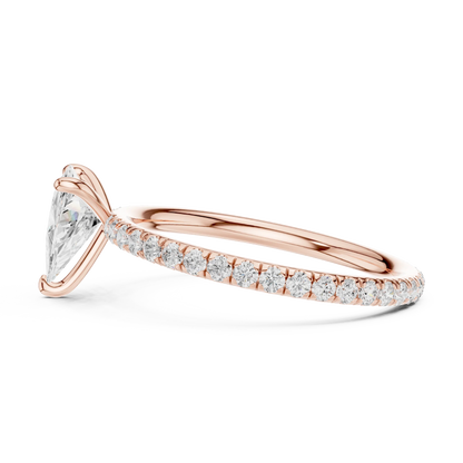 Side profile of rose gold trillion cut solitaire ring with thin pavé diamond band and elevated center stone