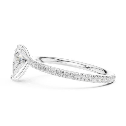 Side view of white gold trillion cut solitaire ring with thin pavé diamond band and raised setting