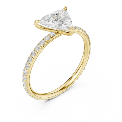 Front view of yellow gold trillion cut solitaire ring with thin pavé diamond band and center gemstone
